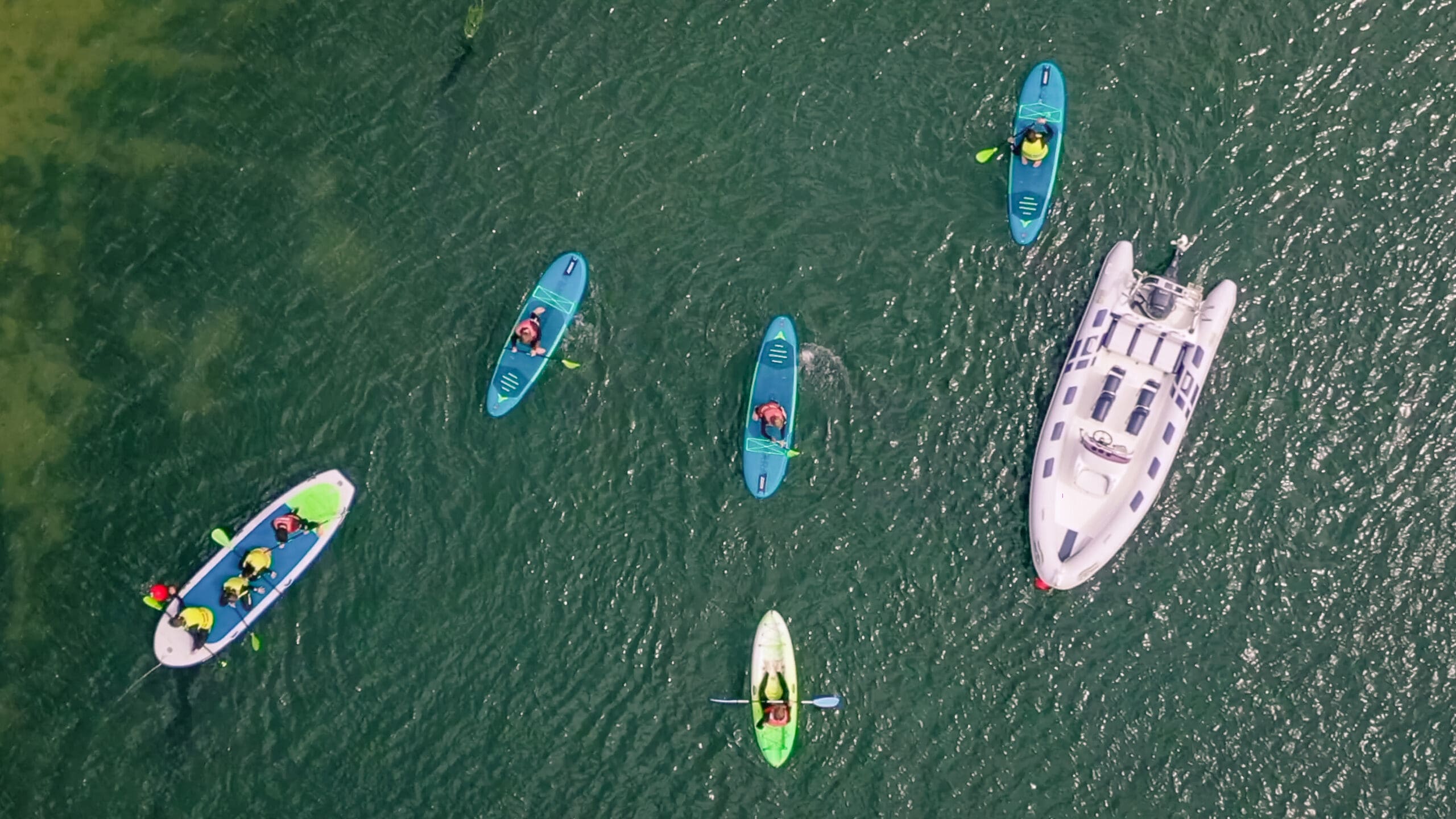 Top places to Paddleboard in Cornwall: The Best Places to Explore - Camel Ski School birds view picture taken of people paddleboarding the camel estuary
