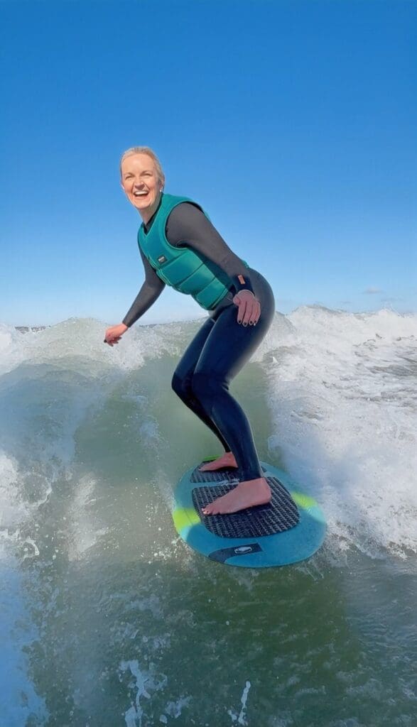 woman wakesurfing on the camel estuary with camel ski school during summer in cornwall