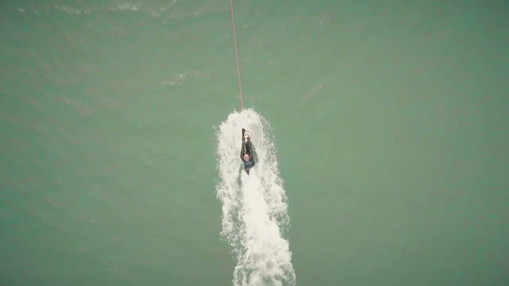 person waterskiing behind a motorboat with camel ski school in cornwall